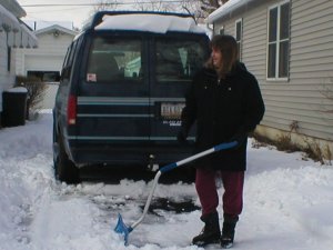 [Mom shoveling the driveway]